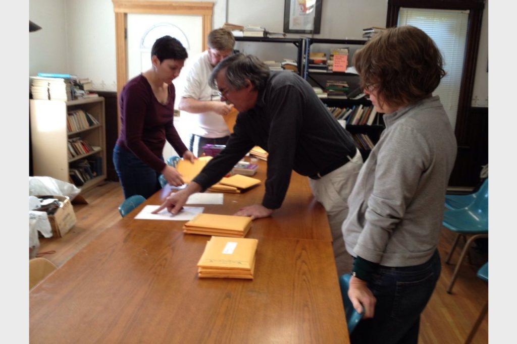 The team finishes up the last pile (international mailings). Photo by: Kristina England